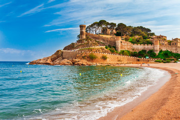 Sea landscape Badia bay in Tossa de Mar in Girona, Catalonia, Spain near of Barcelona. Ancient medieval castle with nice sand beach and clear blue water. Famous tourist destination in Costa Brava