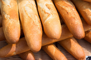 Baguettes, the famous long and thin french bread. Close up of some baguettes in a row.