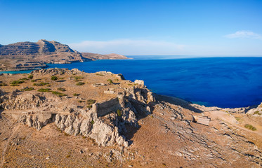 Fototapeta na wymiar Aerial birds eye view drone photo Feraklos castle near Agia Agathi beach on Rhodes island, Dodecanese, Greece. Panorama with sand and clear blue water. Famous tourist destination in South Europe