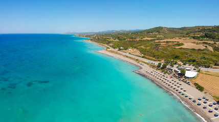 Fototapeta na wymiar Aerial birds eye view drone photo beach on Rhodes island, Dodecanese, Greece. Panorama with nice lagoon and clear blue water. Famous tourist destination in South Europe