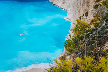Lonely catamaran yacht in blue bay of Navagio beach. Azure turquoise sea water pattern near...