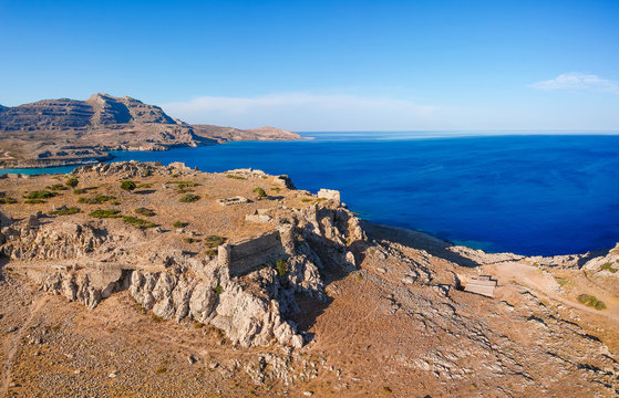 Aerial birds eye view drone photo Feraklos castle near Agia Agathi beach on Rhodes island, Dodecanese, Greece. Panorama with sand and clear blue water. Famous tourist destination in South Europe