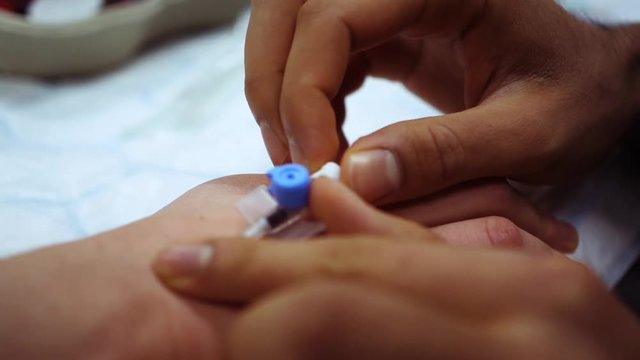 Medical procedure between doctor and patient giving blood