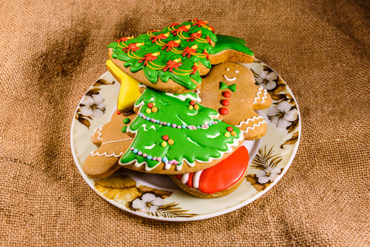 Plate with different christmas gingerbread cookies on a sackcloth