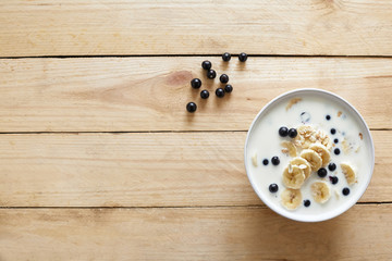 Breakfast: oatmeal with bananas, blueberries, chia seeds and almonds. Top view