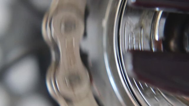 Closeup of Chain and sprocket detail on a fixie style bicycle. Rotating and power transfer.
