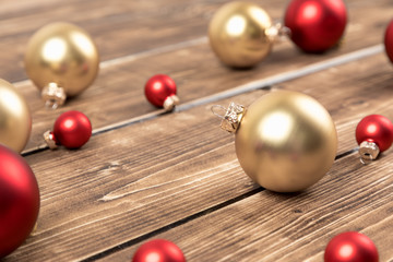 red and gold christmas balls on a wooden background