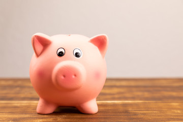 pink piggy bank on wooden background