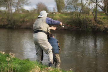 Father and son fishing on the river