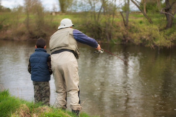Fototapeta na wymiar Father and son fishing on the river
