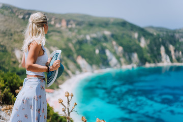 Young woman in front of Petani beach Kefalonia admiring highly excited picturesque panorama of...