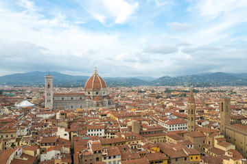 Fototapeta na wymiar Top panoramic cityscape view of Florence, capital of Tuscany region,plenty of roof top renaissance architectures and Piazza del Duomo, Cathedral of Santa Maria del Fiore is major tourist attraction.