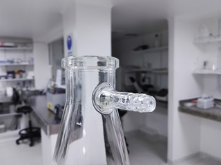 Buchner, vacuum, filter, suction, side-arm flask or Kitasato flask. Thick-walled Erlenmeyer glass flask with a short glass tube and protruding hose barb. Laboratory glassware for scientific research