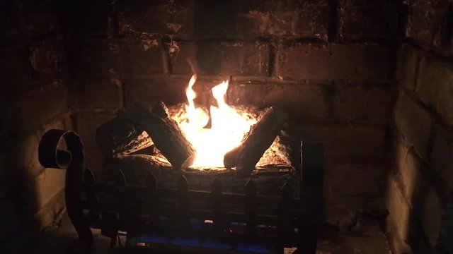 Slow motion burning fireplace and wood burning at home on a cold winter day.