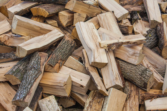 Woodpile of chopped lumber. Pile of wood logs. Stacked firewood timber