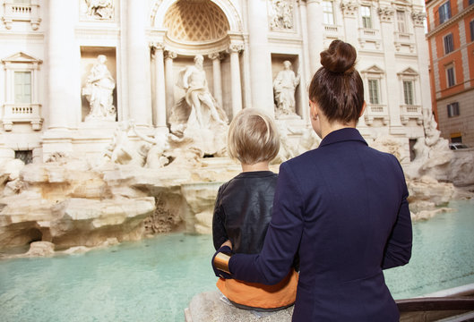 young mother and daughter tourists exploring attractions