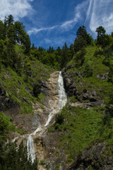 Fototapeta na wymiar Waterfall in a mountain valley near Reit-im-Winkl in the Bavarian Alps in Germany