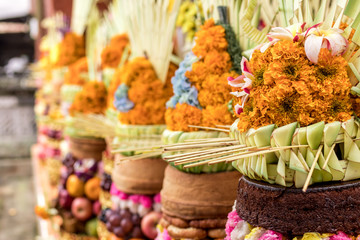 Traditional balinese offerings to Gods with fruits in basket.