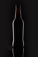 black beer bottle on the black