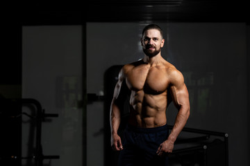 Fototapeta na wymiar Man In Gym Showing His Well Trained Body