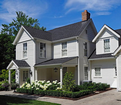 white clapboard house with gable and portico entrance
