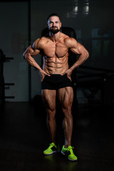 Fototapeta na wymiar Bodybuilder Performing Most Muscular Pose