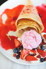 Baked waffles with ice cream and berry .