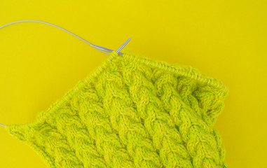 Yellow and green coats of wool lie on the table.