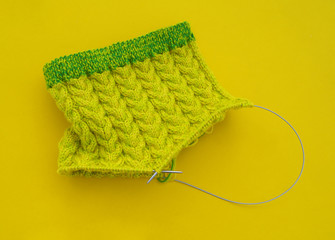 Yellow and green coats of wool lie on the table.