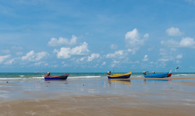 Colorful long-tail boat on the beach, Thailand.Tropical beach, long tail boat,blue sky, gulf of Thailand