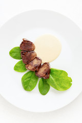 fried turkey hearts with spinach and gravy sauce