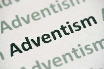word Adventism printed on paper macro