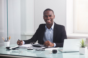 Smiling African Businessman Working At Workplace