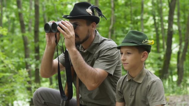 Hunter and son in the forest