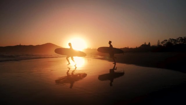 Sunrise Surfers Running Down Beach Byron Bay Australia
