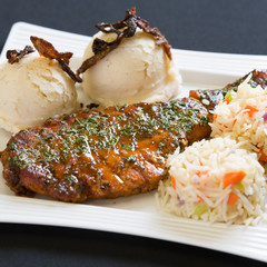 Shot of steak and potatoes on a white plate