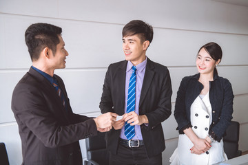 Fototapeta premium Young businessman giving name card to his customer.