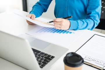 business woman accountant or banker making calculations Bills. doing finances in the office, economy concept through laptop