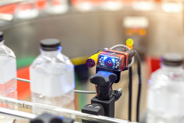 Microscan, MicroHAWK and MicroVISION includes the barcode reading technology for the production line of plastic bottles on a conveyor belt in mineral water factory.