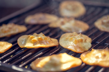 Baked sheep cheese on a grill grille. Polish regional sheep's cheese produced in the mountains.