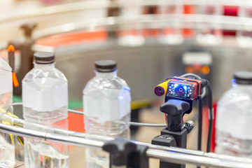 Microscan, MicroHAWK and MicroVISION includes the barcode reading technology for the production line of plastic bottles on a conveyor belt in mineral water factory.