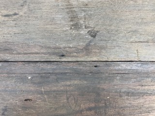 Old natural light brown wooden table with many cracks and scratches, using for background