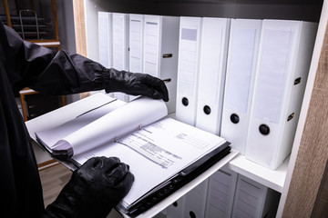 Thief Holding Invoice Folder