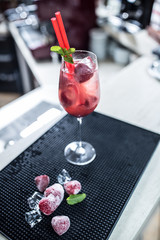 Strawberry lemonade or alcoholic cocktail  on bar table.