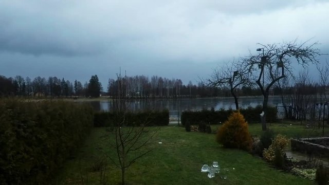 Timelapse of dramatic clouds flowing over garden