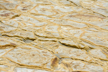 Textured ground surface with mineral layer