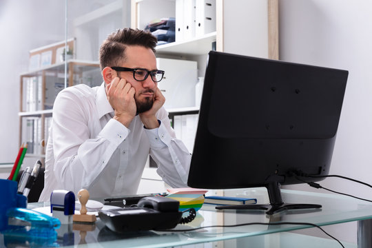 Stressed Businessman Sitting In Office