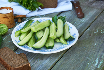 Slices of fresh cucumbers with salt on a plate