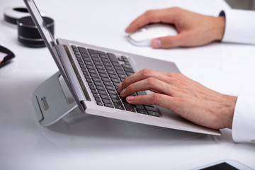 Businessman Typing On Laptop Keypad
