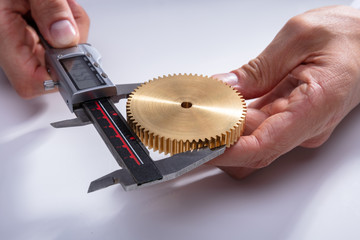 Person Measuring Gear's Size With Digital Caliper